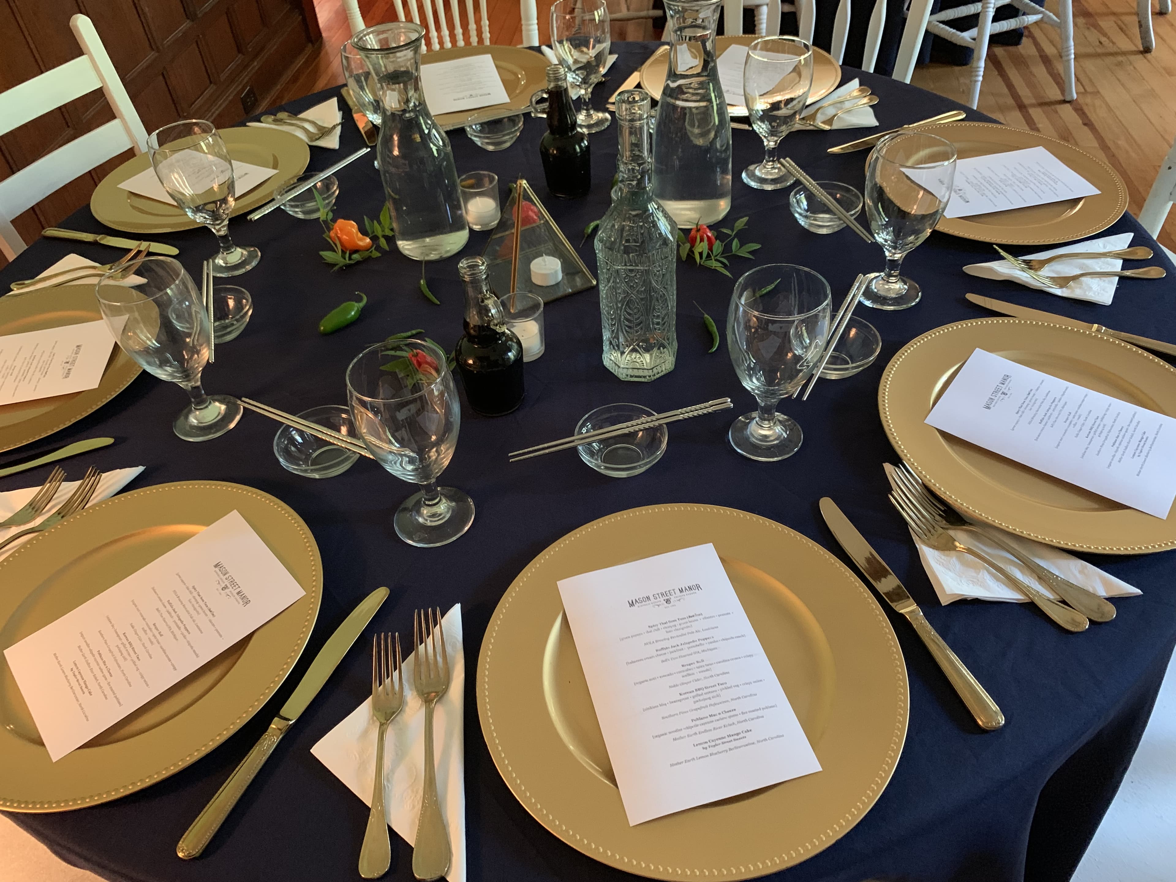 Elegant table setting with gold chargers and navy linens